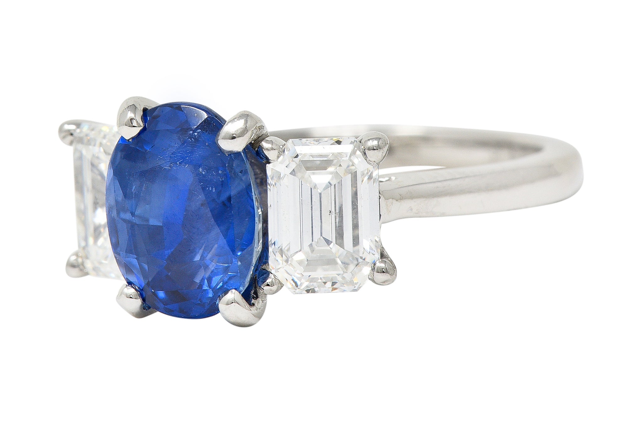 Contemporary 4.82 CTW Oval Cut No Heat Sapphire Emerald Cut Diamond Platinum Three Stone Ring GIA Wilson's Estate Jewelry